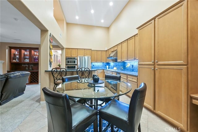 tiled dining room with a high ceiling