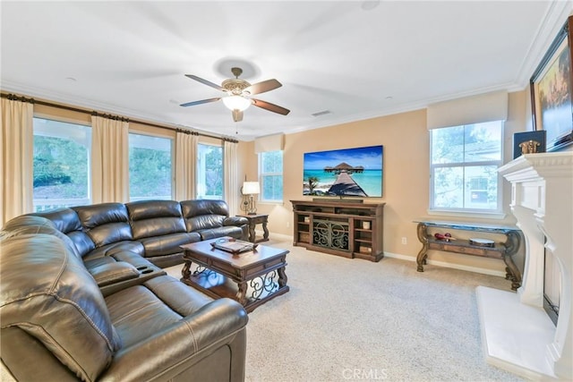 carpeted living room with ceiling fan and ornamental molding