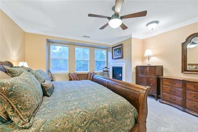 bedroom featuring carpet, ceiling fan, and crown molding