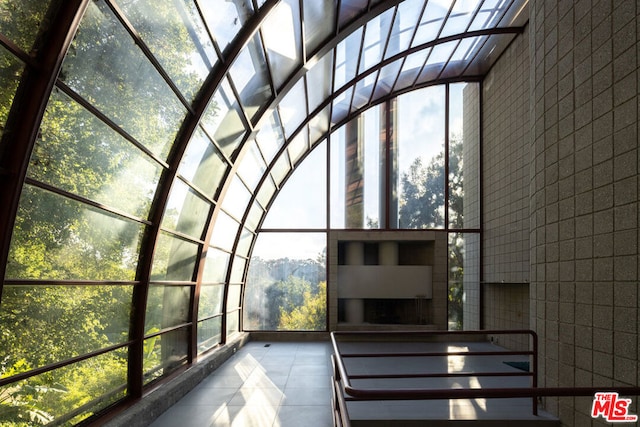 unfurnished sunroom with a wealth of natural light