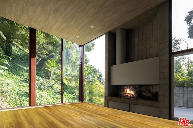 unfurnished sunroom with a healthy amount of sunlight and wood ceiling