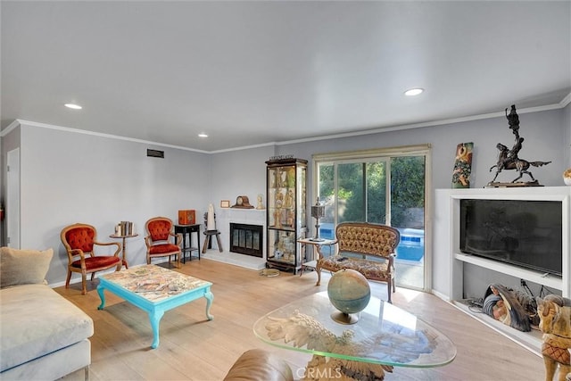 living room with crown molding and light wood-type flooring