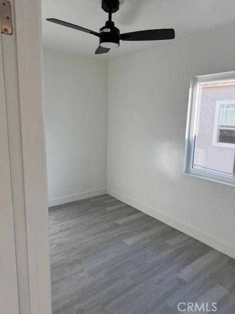 unfurnished room with hardwood / wood-style floors and ceiling fan