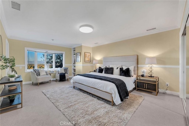 bedroom with light colored carpet and crown molding