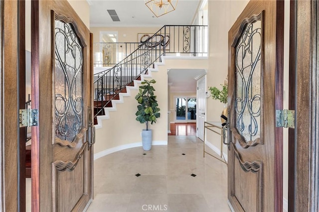 foyer featuring ornamental molding