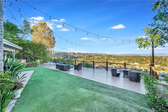 view of yard featuring a mountain view, an outdoor hangout area, and a patio area