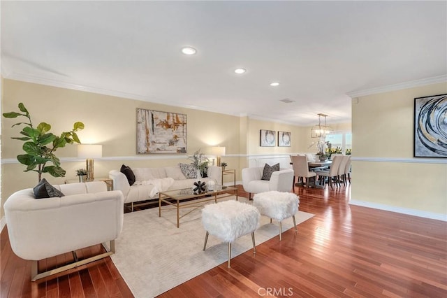 living room with crown molding and hardwood / wood-style floors