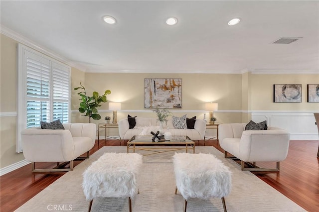 living room featuring hardwood / wood-style flooring and ornamental molding