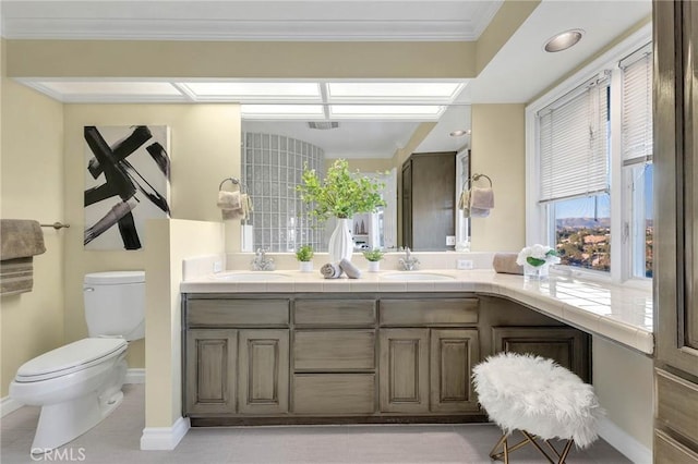 bathroom with tile patterned floors, vanity, toilet, and ornamental molding