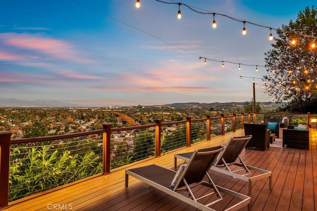 deck at dusk with an outdoor living space