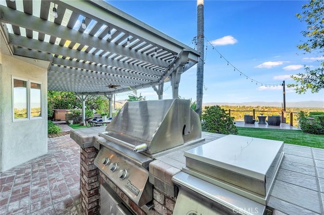 view of patio / terrace with a pergola and area for grilling