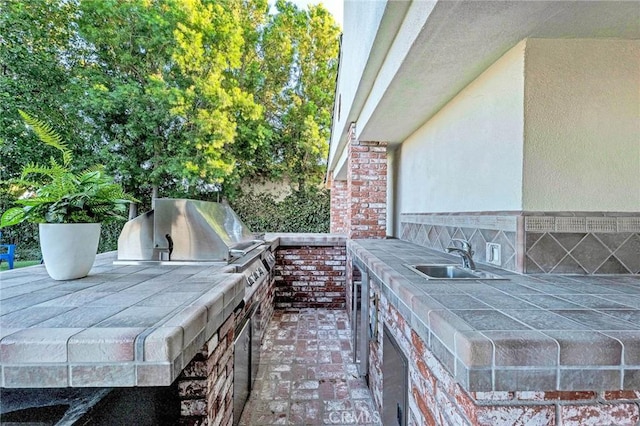 view of patio / terrace with area for grilling, sink, and an outdoor kitchen