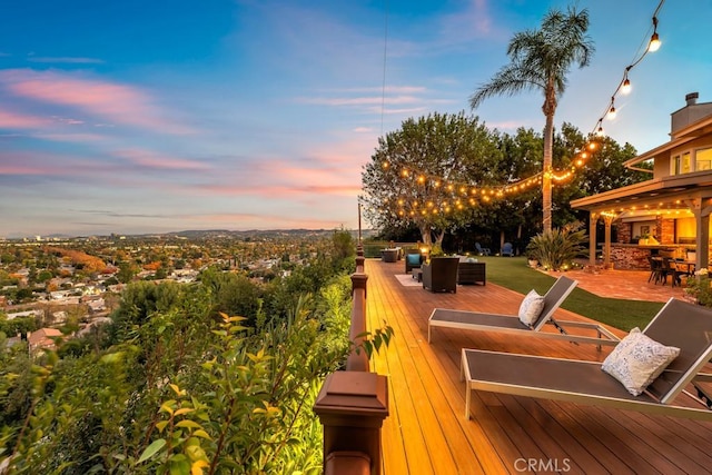 deck at dusk featuring outdoor lounge area