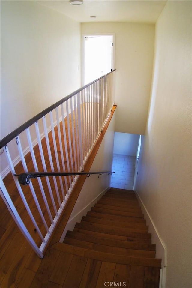 stairs featuring hardwood / wood-style floors