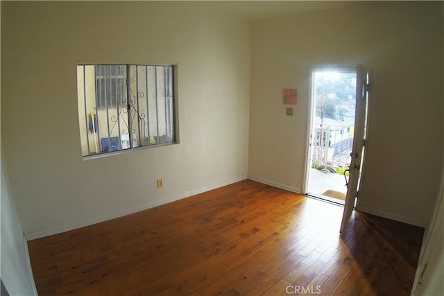 spare room with wood-type flooring