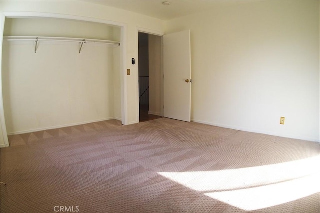 unfurnished bedroom with a closet and carpet