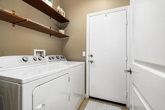 clothes washing area featuring washer and clothes dryer