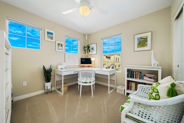 carpeted office space featuring ceiling fan