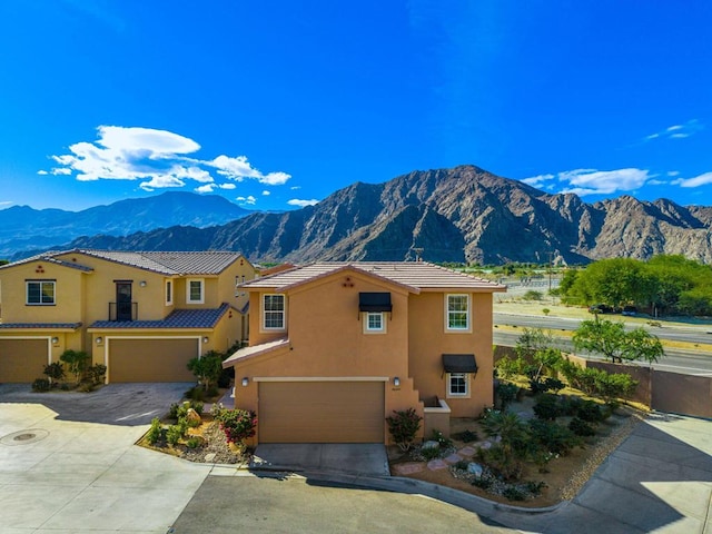 view of front of house with a mountain view and a garage