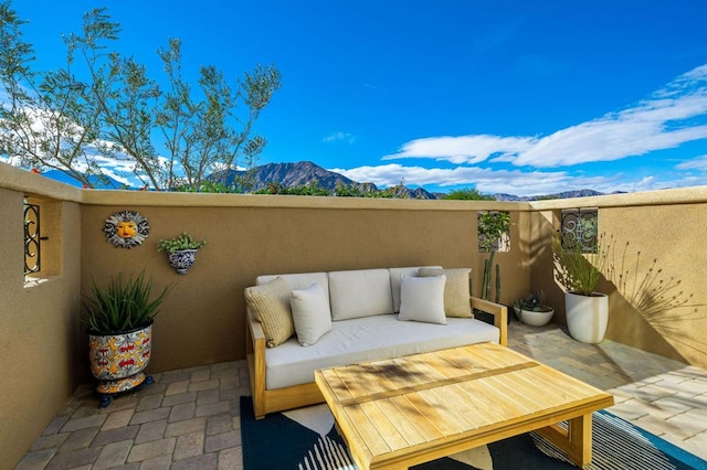 balcony with a mountain view and an outdoor living space