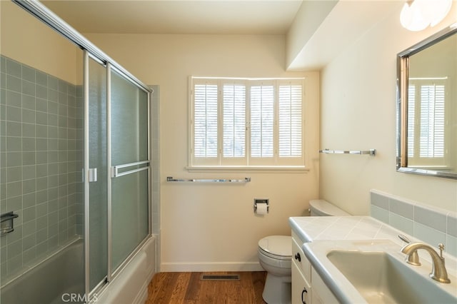 full bathroom with vanity, toilet, wood-type flooring, and a wealth of natural light