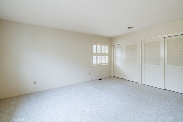 unfurnished bedroom with light carpet