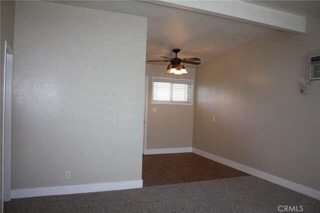 spare room featuring beamed ceiling, an AC wall unit, and ceiling fan