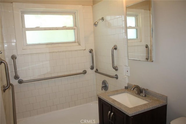 bathroom with a wealth of natural light, shower / bath combination, and vanity