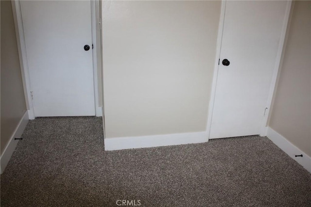 unfurnished bedroom featuring carpet floors and baseboards