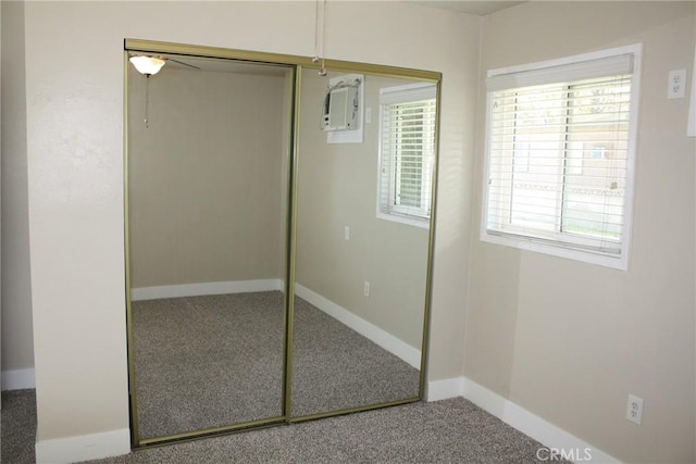 interior space featuring a closet, multiple windows, and baseboards