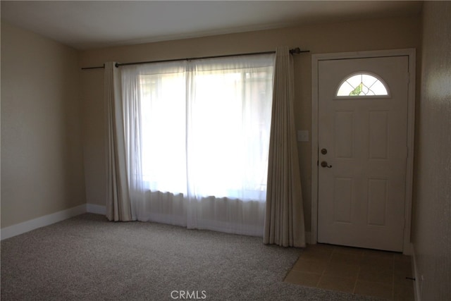 entrance foyer featuring light colored carpet