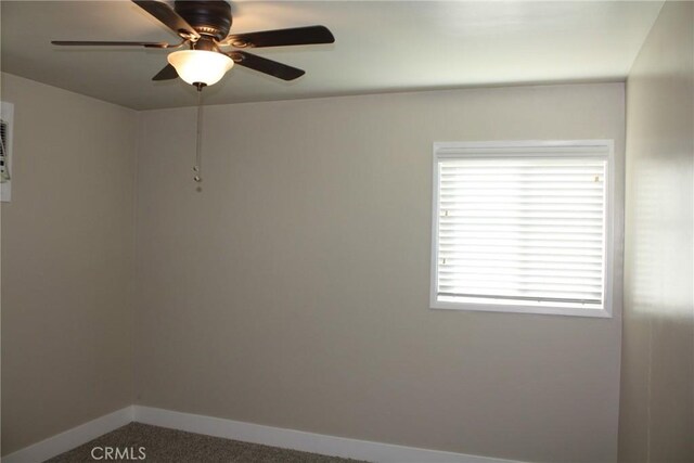 spare room featuring carpet floors, baseboards, and a ceiling fan