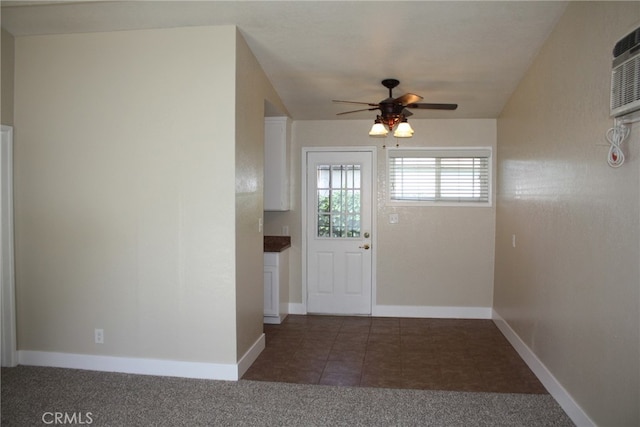 entryway with ceiling fan and dark tile patterned flooring