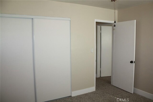 unfurnished bedroom with carpet and a closet