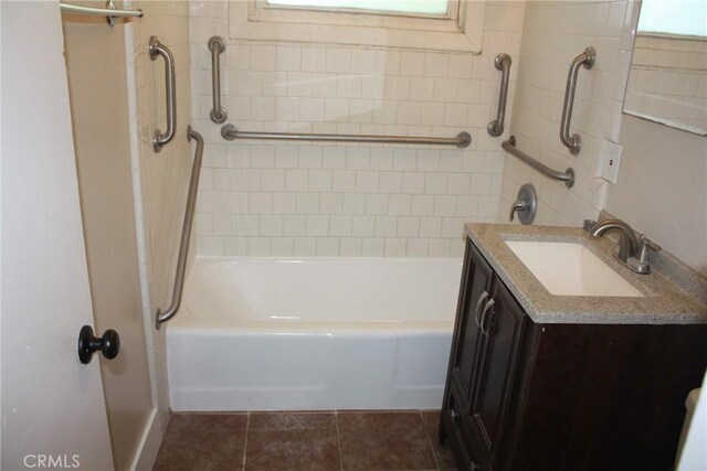 bathroom with bathing tub / shower combination, tile patterned flooring, and vanity