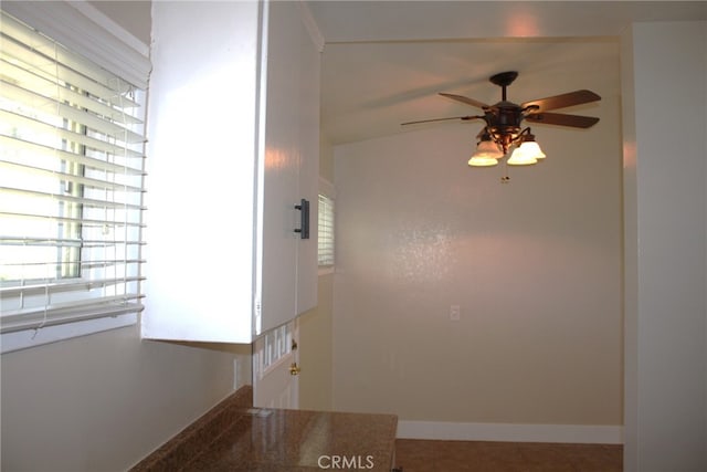 hall with tile patterned floors