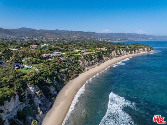 aerial view with a water and mountain view and a beach view