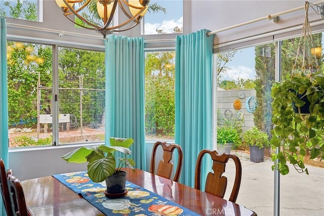 dining room featuring a chandelier and concrete flooring