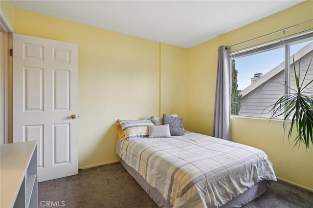 bedroom featuring dark colored carpet