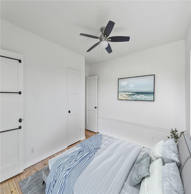 bedroom with ceiling fan and light wood-type flooring