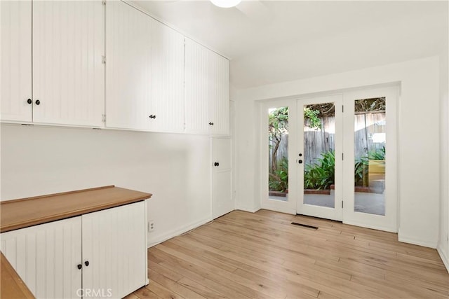 entryway featuring french doors and light hardwood / wood-style flooring