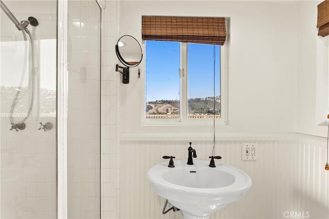 bathroom with sink and tiled shower