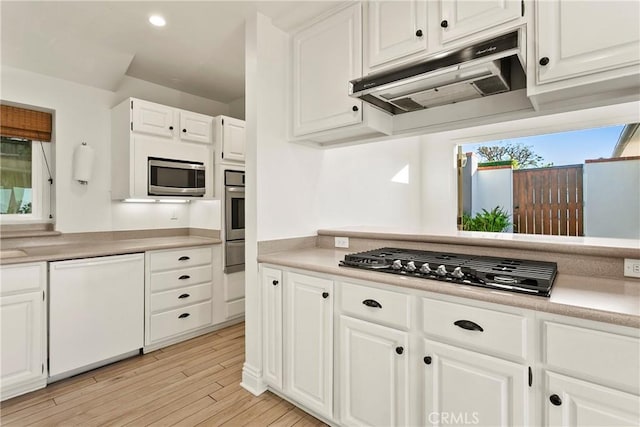 kitchen featuring light hardwood / wood-style flooring, white cabinets, and appliances with stainless steel finishes