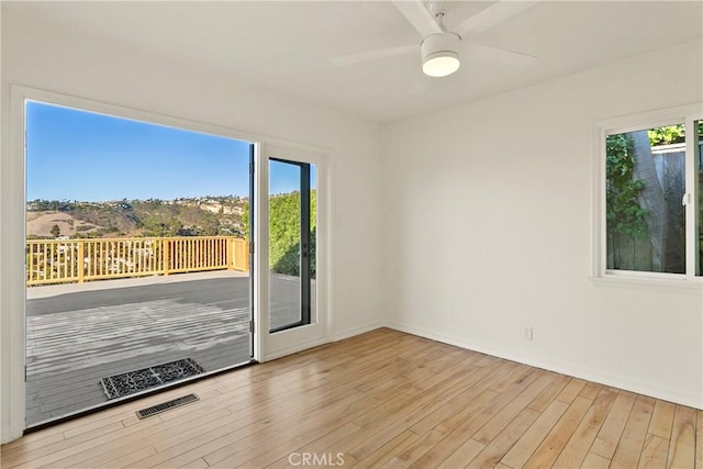 spare room with light hardwood / wood-style floors and ceiling fan