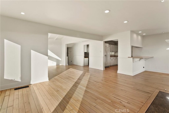 unfurnished living room featuring light hardwood / wood-style floors