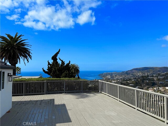 wooden terrace featuring a water view