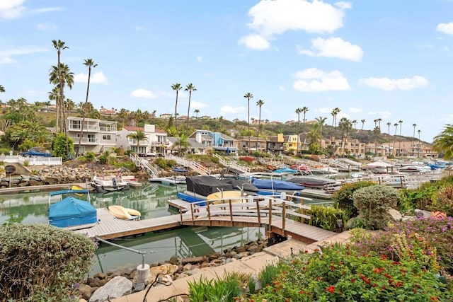 view of community featuring a boat dock and a water view