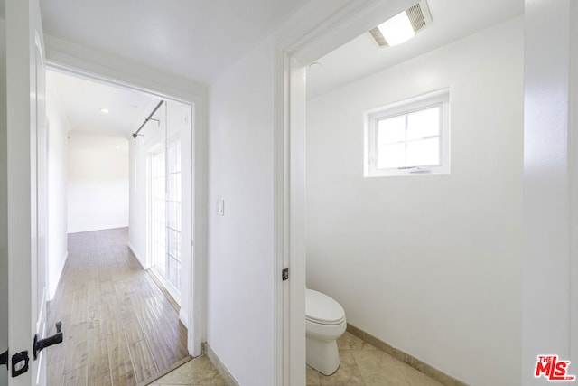 bathroom with tile patterned floors and toilet