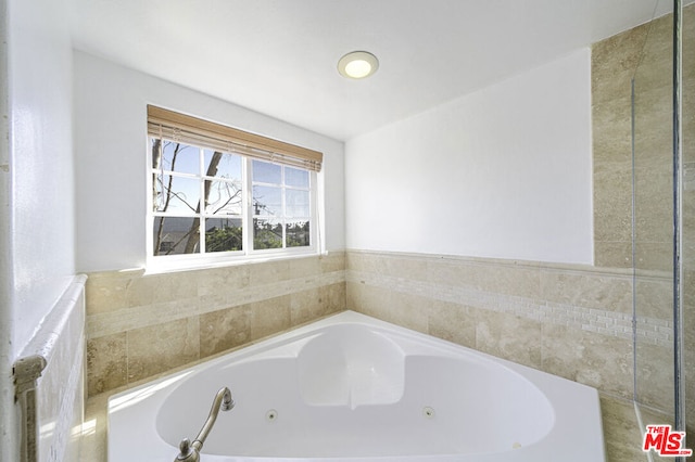 bathroom featuring tiled bath