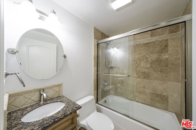 full bathroom featuring tasteful backsplash, vanity, enclosed tub / shower combo, and toilet